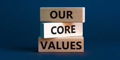 Our core values symbol. Concept words 'Our core values' on wooden blocks on a beautiful grey background. Business and our core values concept. Copy space.